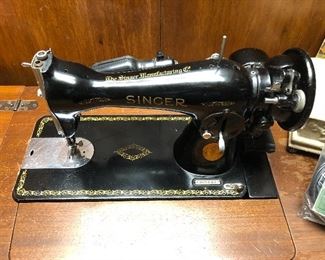 Singer 15–91 electric heavy duty all metal sewing machine 1949 per serial number. Powers on and moves freely. Includes many extras. Clean cabinet drawers. 
