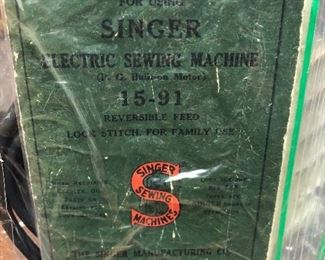 Singer 15–91 electric heavy duty all metal sewing machine 1949 per serial number. Powers on and moves freely. Includes many extras. Clean cabinet drawers. 