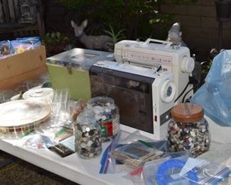 Sewing machines, buttons, thread and sewing basket