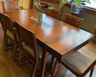 Dining room table with built in leaf adds extra foot of length. So sturdy you could dance on it ;)