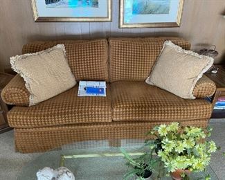 . . . an upholstered couch with throw pillows