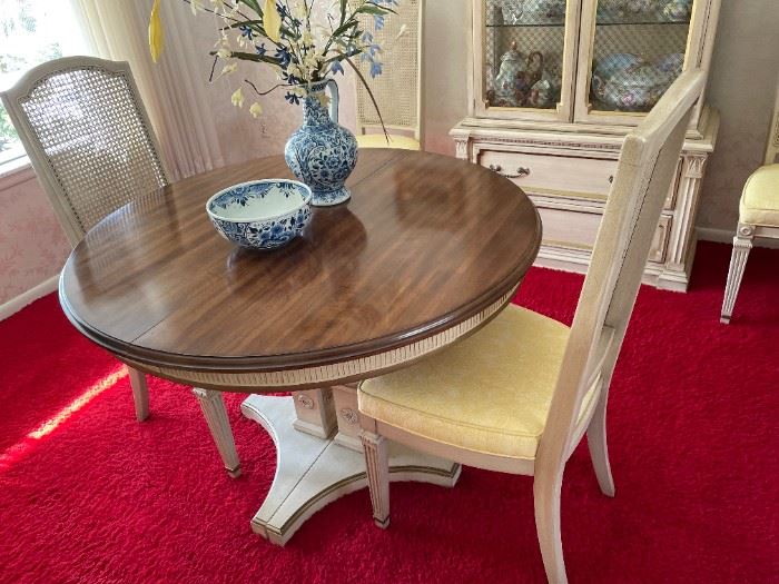 This dining table has four chairs and a matching server.
