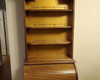 Small roll top secretary desk with 4 shelves and 1 drawer. Rolltop opens up to reveal multiple storage cubbies. 30x18x84" Drawer 24x11x2"

https://ctbids.com/#!/description/share/768263