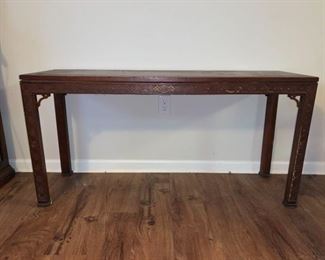 Kindel wooden table with decorative flourishes and signs of wear on each leg. There is a weak point on one of the legs that has a separation point as well. The top surface has some scuffs visible too 54x17x27.

https://ctbids.com/#!/description/share/768311