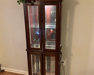 This is a Cherry and glass curio cabinet by Amelia. It has a top light with rolled toggle switch that is in working order. There is one adjustable shelf in the top and bottom made of glass and there are no signs of damage on the glass or the mirrors. The cherry wood is beautiful and shows no sign of wear. 24x11x78 Shelves 21x10x16

https://ctbids.com/#!/description/share/768314