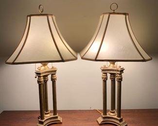 A matching set of brass lamps. Both lamps have dual fixtures and have working brass pull chains. They feature decorative columns that make up the stem and have artistic patterns on the feet. The lamp shades are in good condition and are iron framed. 30x16”

https://ctbids.com/#!/description/share/768312