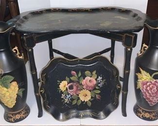 Large wooden serving tray with table painted with birds scene and has a few minor scratches and cracks on the back. The table mount is missing screws but will still stand on it’s own. The small tray is metal and painted with a floral pattern. The black ceramic Vases are matching and trimmed with gold and painted with fruit and floral patterns for accents.

https://ctbids.com/#!/description/share/768295