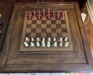 A wooden gaming table complete with chess/checkers board and reverse side for backgammon. There is a complete chess set and complete backgammon set as well as a complete set of dominoes. The table itself has a few scuffed surfaces but overall is in good working condition. There are two pull out drawers to store pieces on each side. 28x28x31”.

https://ctbids.com/#!/description/share/768302