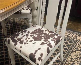 Closer view of cowhide seats on vintage chairs