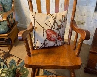 Wooden rocking chair with decorative bird pillow