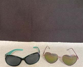 Pair of sunglasses. Turquoise/Black with jewels. (one jewel is missing), Metal frame glasses with heart shaped lens. Pair $12