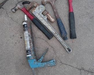 Lot of hammers, pipe wrench and caulk gun