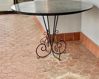 $250 - Vintage table with black stone top and metal stand - AS IS - table is worn due to use and age - 46" diameter, 30" H