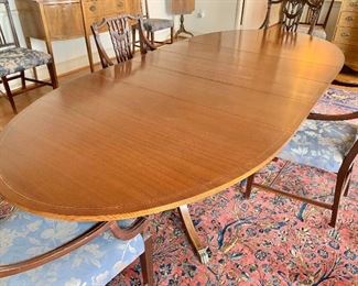 $995 - Federal style double pedestal, inlay, banded dining table with brass cap feet- 8'7" L with three 12" leaves, approx 62" without leaves - 45" W x 30" H