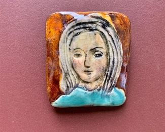 $30 - Glazed ceramic portrait pin; 1.5" H x 1.25" W
