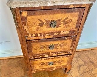 $125 -Louis XV style marble top 3 drawer stand with foliate inlay, ormolu pull and mounts. Some loss of veneer, needs repair. 32" H x 18" W x 12.5" D