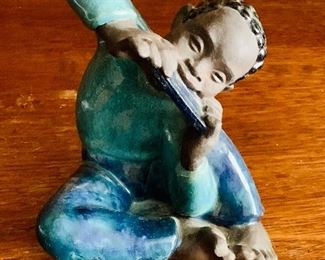 $195 - Emilie Scrivens signed faience figural sculpture; boy with harmonica; 6.5" H x 6" W