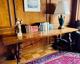 $750 - Vintage wooden plank top refectory table with hand forged iron stretcher raised on “S” scroll supports. Light wear due to use. 86” (L) x 28” (W) x 30” (H)