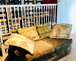 Safari-themed moss green loveseat w/ oversized throw pillows 
