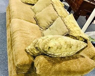 Safari-themed moss green lounge sofa w/ oversized pillows