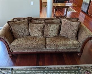 Sofa and loveseat with rolled arms, loose pillow backs and bun feet.