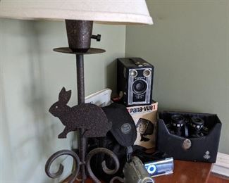 Folk art bunny lamp, binoculars, Brownie camera, pana-vue slide viewer.