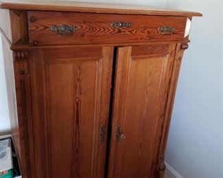Wood cabinet can hold linens or office items
