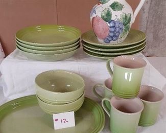 LOT 12 NEW PRICE $50.00 Le Creuset dinnerware. 15 pieces. color kiwi. salad/luncheon plates, soup bowls, 4 cups, cereal bowls, platter. Pitcher Brand Brand is not known.