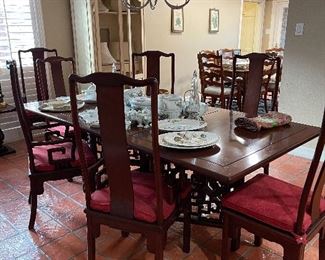 Asian style dining table, mahogany, 20th century. Priced with 8 chairs, upholstered seat cushions. 