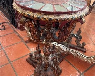 Antique Italian side table, round mirrored top, ornate acanthus-carved figurative base, polychrome painted.