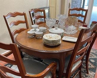 French mahogany oval dining table.  6 cherry ladder back dining chairs. Table & chairs priced separately.