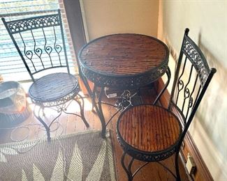 10.	Iron & wicker bistro table 27 ½”R with 2 chairs (table missing a stretcher) $90 as is 