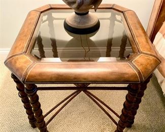 There is a pair of these tables available. Glass top leather rimmed table. Notice the tooling detail on the leather. Beveled smoked glass. Iron base with great detail. Measures 27" square, 23" high.