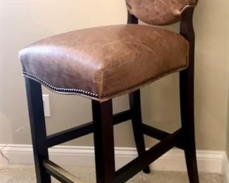 Leather bar stool with nail head trim. Brass trim along foot rest. 18" wide x 21" deep x 4" high. By Designmaster.