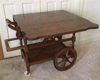 Drop leaf tea cart with pull out glass tray.
