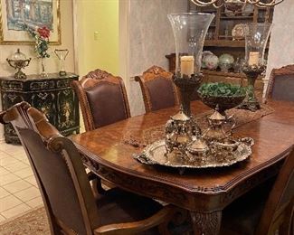 Gorgeous & oh so elegant. This table seats 8 and there is an additional leaf that can be used to expand the table. 
Beautiful decor- silverplate tea set, serving tray, large candleholders big enough to not get lost on this table. 