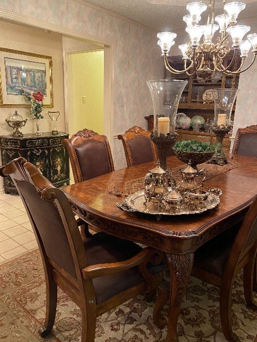 Gorgeous & oh so elegant. This table seats 8 and there is an additional leaf that can be used to expand the table. 
Beautiful decor- silverplate tea set, serving tray, large candleholders big enough to not get lost on this table. 