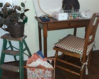 Small desk, sewing notions, silk plants, and vintage step ladders