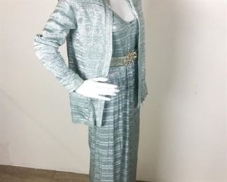Lot	78	Vintage Custom Creation Silver / Blue Lame Gown	Vintage Custom Creation Silver / Ice Blue Lame Gown Sleeve-Less - 12 Button back of Gown Closure Matching Two Pocket Waist/ Short Jacket has matching belt Rhinestone Buckle measures 30" Ice Blue Lining. No Sizing Tag - Similar to a woman's size 8 )

