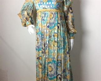 Lot	84	Vintage Printed Gold Lame Accent Gown	Vintage Turquoise Printed Gold Lame Accented Gown Golden Fringe on Collar and Bodice Pleaded on Skirting Portion of Gown No Markers Label - tag indicates Size 8
