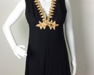 Lot	95	Vintage Lord & Taylor Cocktail Dress	Vintage Lord & Taylor Black Ornate Cocktail Dress Golden Cording - Pearl-like Beads & Rhinestones patterning decorate the collar & front of dress back zipper closure Condition - Some Damage to front embellishment - see photos SIZE 7-8
