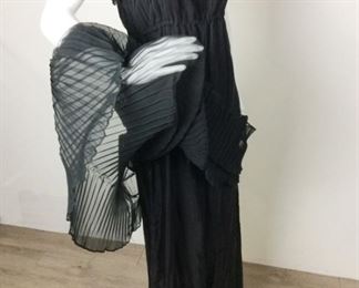 Lot	96	Vintage Sharon Rothfeld - "Sharon's World" Gown	Vintage Sharon Rothfeld - "Sharon's World" Black Spaghetti Strap Full Skirt - Full Length pleaded with zipper back Material fabric 100% Polyester - 100% Rayon Lining Tag Size 7 / 8
