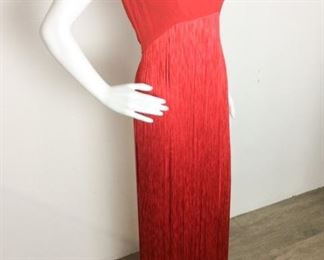 Lot	97	Vintage Estevez Red String Gown	Vintage Estevez Red String Fringe Gown Measures under arm to bottom 51 " with 18" Slit from bottom up legs No Sizing label - similar to a women's 8
