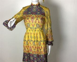 Lot	100	1960 Original DES-L CON-TUR Silk Dress	1960's Original DES-L CON-TUR "often copied never equaled" Silk Dress Yellow with India inspired design - Gold Lame rowed accent with long sleeve - cuffs are elastic matching material belt / tie - measures 46" long & 6" wide No Label with sizing - measures approximately 28" around waist
