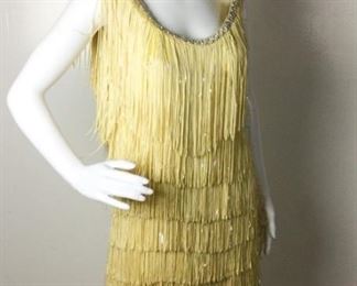 Lot	106	Vintage String & Opalescence Fringe Silk Dress	Vintage Butter Cream Tiered String Dress has intermittent Opalescent Fringe with a lower scoop back Rhinestone circles out-line the collar & back scoop ***** NO SIZING - NO LABELS ***** ( educated guessing is 6- 8 women's)
