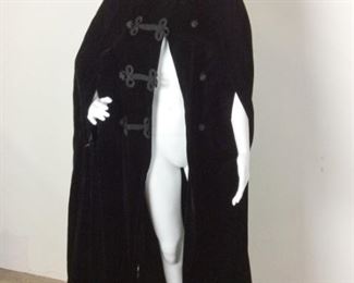Lot	115	Original Camdi Wrap Velvet Hooded Cape	Vintage Lord & Taylor Camdi Wrap Black Velvet Hooded Long Cape Ornate Corded Oriental Style Fasteners - Long Black Tassel off hood WOW Make a Dramatic Appearance Wearing This On of a Kind Cape ***NO SIZING *** (Similar to a women's medium )
