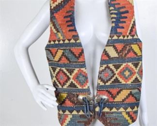 Lot	192	Design by Hester - NM - Woven / Leather Vest	A Design by HESTER - New Mexico - B. Hester Vest fashioned from Klim Rug likely Turkey the blue is this design is rare & hard to find Back leather is Pig Skin - Rayon Lining Hand Stamped Sterling Silver Concho Fasteners SIZE - MEDIUM (40)
