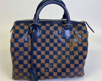 Lot	197	Louis Vuitton Speedy 30 Blue Sequin Damier Purse	Authentic Louis Vuitton Speedy 30 Blue Damier Ebene Paillettes Limited Edition Purse.&nbsp; Signature Damier Ebene canvas is re imagined as Damier Pailettes with sequins embellishment on the exterior. Two handles with zippered closure at the top. Blue alcantara lining with zippered inner pocket.&nbsp;Protective feet at base. Includes clochette with keys and padlock. Excellent condition. 11.5" l x 7" w x 9" h
