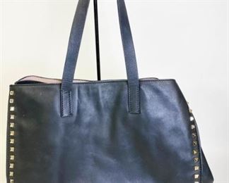Lot	201	Valentino Garavani Black Leather Rock Stud Tote	Authentic Valentino open top black leather shoulder bag, with silver tone rockstud accents, all studs intact, Condition: Ink pen marks and stains inside and some scratches and wear to bottom. Size 15" l x 10.5" h x 7" w
