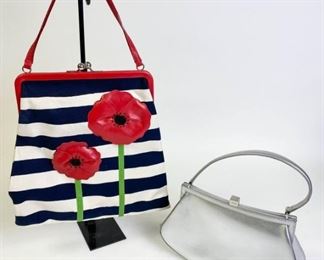 Lot	227	Two Small Moschino Purses	Cheap and Chic blue white red framed canvas single handle bag with beaded leather poppy applique, silver tone hardware, twist lock closure, red fabric lining with some discoloration by zipper, minor marks on outside. Silver Moschino handbag with single handle, black fabric lining, zipper pocket inside, snap close, minor scratches and wear Flower - 12" l x 12" w x 1" d Silver - 11" l x 6.25" w x 3" d
